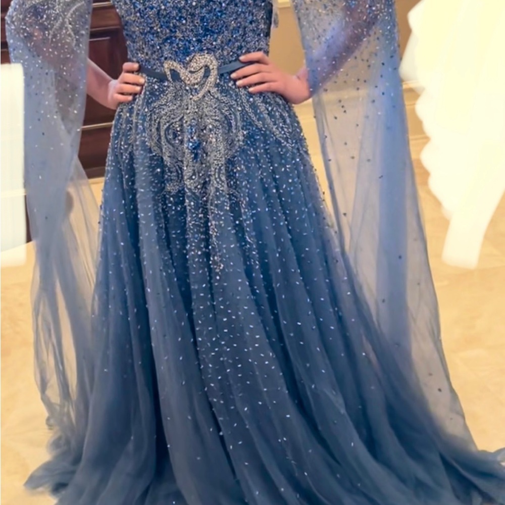 Long A-line beaded gown with train and cape sleeves. Very fancy